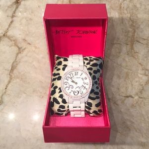 Betsey Johnson White watch with pink stone bezel.